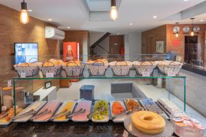 a display case filled with different types of food at Plaza Spania Boutique Hotel in Rio de Janeiro