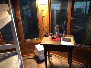 a table with figurines on it in front of a window at Bequemschlafen in Heidenau