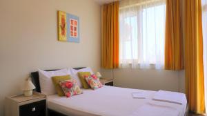 a bedroom with a white bed and a window at Вила Силва - Villa Silva in Bŭlgarevo +95 photos
