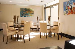 a dining room with a table and chairs at Ayres Apartments Recoleta - Uriburu 1756 in Buenos Aires