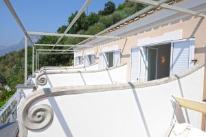 a balcony of a house with a staircase at Il Barilotto in Positano