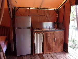 a kitchen with a refrigerator and a sink in a tent at LA FONTAINE D'ANNIBAL in Buis-les-Baronnies