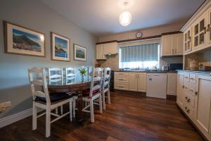 a kitchen with a table and chairs and a dining room at Arden Bungalow in Baltray