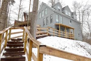 a house in the woods with snow on the ground at Ski-InandSki-Out Ghent Cabin with Mountain Views! in Ghent
