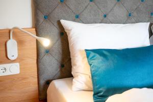 a bedroom with a bed with a pillow and a lamp at Chalet Tolder in San Candido +28 photos