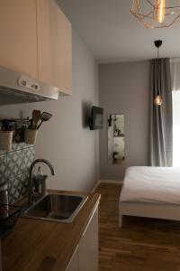 a kitchen with a sink and a bed in a room at S&L3 REPUBLIC ZAGREB CENTER in Zagreb