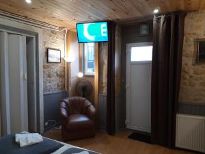 a room with a chair and a sign on the wall at Les Buissonnets in Saint-Honoré-les-Bains