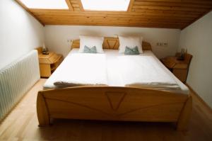 a bedroom with a large bed in a attic at Haus Dorfer in Döbriach