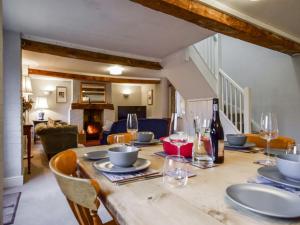 a wooden table with plates and wine glasses on it at Granary, Cheltenham in Cheltenham