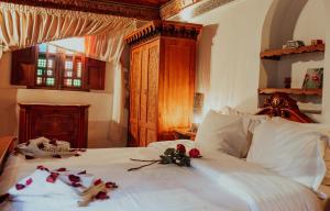 a bedroom with a bed with flowers on it at Riad Toyour- Riad of birds in Fès