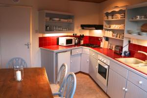 a small kitchen with a table and a microwave at The Boathouse for two, St Davids, Garage Parking in St. Davids