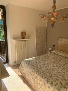 a bedroom with a bed and a window at Appartamento Levico lake in Levico Terme