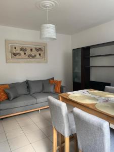 a living room with a couch and a table at Appartamento Levico lake in Levico Terme