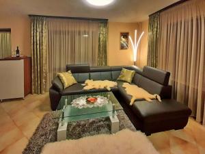 a living room with a couch and a table at Vicky's House in Bük