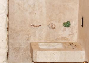 a bathroom with a sink and two rocks on the wall at Casa Ohana-Disfruta del paraiso in Holbox Island +49 photos