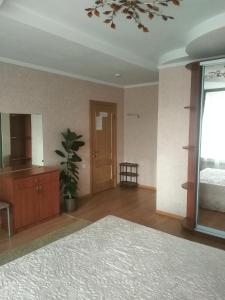 a bedroom with a bed and a dresser and a window at Guest House Lukomorye in Anapa