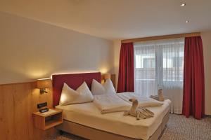 a bedroom with a bed with a large window at Appartement Schörghofer in Filzmoos