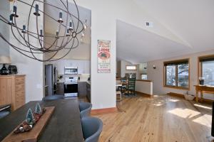 a kitchen and living room with a dining table and a chandelier at Snowcreek V 733 in Mammoth Lakes