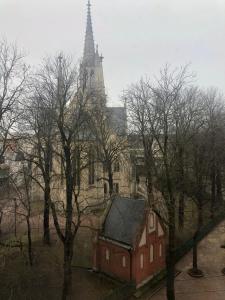 a building in front of a church with a tower at Apartment Katowice Center in Katowice