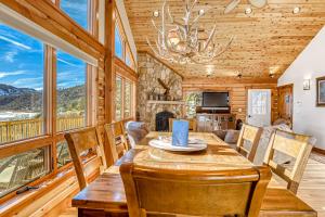 a dining room with a table and chairs and a fireplace at Hawk Perch in Durango