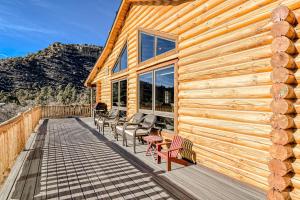 a wooden cabin with chairs and tables on a deck at Hawk Perch in Durango