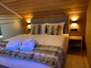 a bedroom with a large bed with two pillows at Chalet RelaxAlp Garfrescha in Sankt Gallenkirch