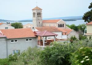 a small town with a church and a tower at Apartmani Nina in Tkon