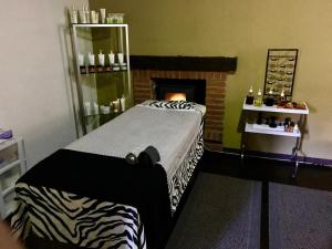 a bedroom with a zebra print bed and a fireplace at Spa Holistico Real Hotel in Mineral del Monte