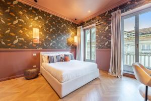 Postel nebo postele na pokoji v ubytování Voluta Suites