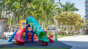 a playground with a slide in a park at Travel Inn Flats Riviera in Riviera de São Lourenço