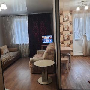 a living room with a couch and a table at Apartment on Plekhanovskaya street 22 in Voronezh
