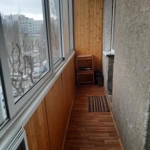 an empty hallway with two windows and a wooden floor at Apartment on Plekhanovskaya street 22 in Voronezh
