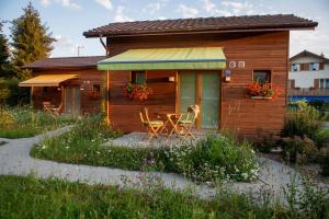 una casa de madera con una mesa y sillas delante de ella en Fiechtehüsli (tiny house), en Huttwil