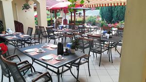 a group of tables and chairs in a restaurant at Haus Marika in Siófok