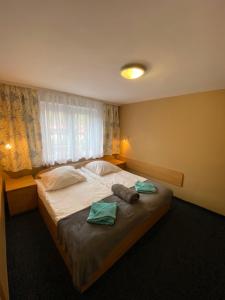 a bedroom with a large bed with towels on it at OW DUET in Karpacz