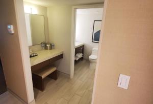 a bathroom with a sink and a toilet at Crowne Plaza Phoenix - Chandler Golf Resort, an IHG Hotel in Chandler