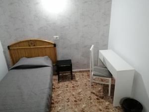 A bed or beds in a room at Alcaravaneras Hostel