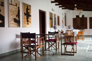 a dining room with a table and chairs at Purity at Lake Vembanad in Mararikulam