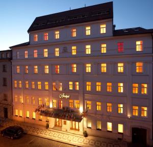 a large white building with many windows at night at Ametyst Hotel Praha in Prague