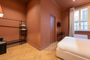 Postel nebo postele na pokoji v ubytování Voluta Suites