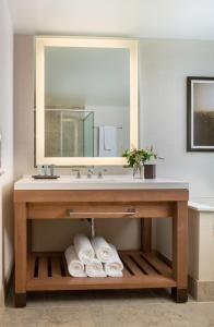 a bathroom vanity with a sink and a mirror at Chateau Elan Winery in Braselton