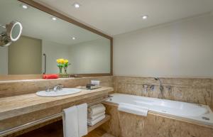 a bathroom with a tub and a sink and a mirror at InterContinental São Paulo, an IHG Hotel in São Paulo