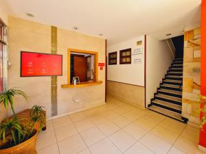 a hallway with a staircase in a building at Pousada Fagundes Varela in Niterói