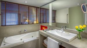a bathroom with a tub and a sink and a bath tub at InterContinental São Paulo, an IHG Hotel in Sao Paulo