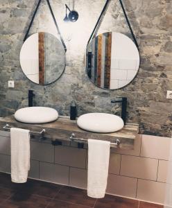 a bathroom with two sinks and three mirrors at Chabela's Suites in La Lajita