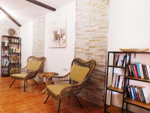 two chairs and a book shelf in a room at Chabela's Suites in Lajita