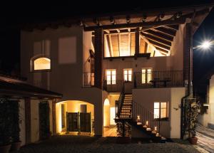 a large white building with a stairway in the night at Acini e Rose in Montalenghe