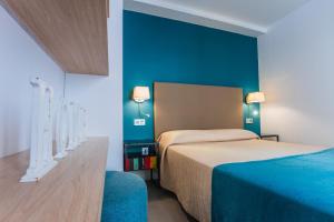 a hotel room with a bed and a desk at Debambu Larios in Málaga