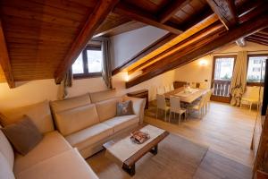 a living room with a couch and a table at Residenza Marconi in Pinzolo