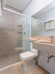 a bathroom with a shower and a toilet and a sink at Hotel Pousada Pacaembu in São Paulo